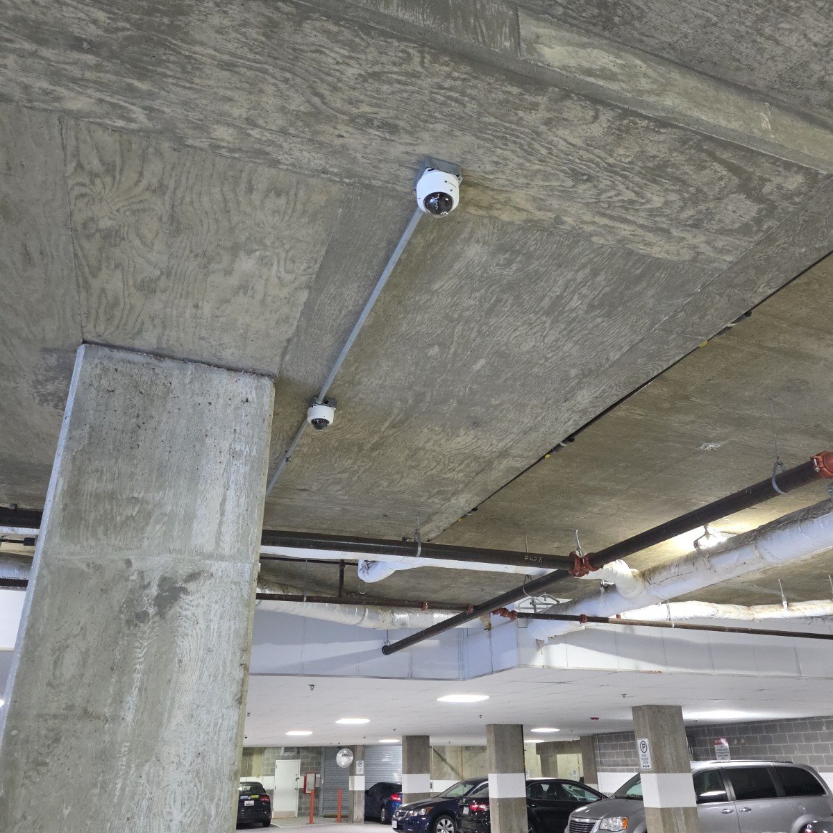 Dome cameras fed by surface conduit in the parking garage